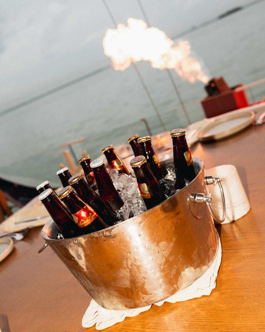 Ice bucket of beers on the table, facing the sea