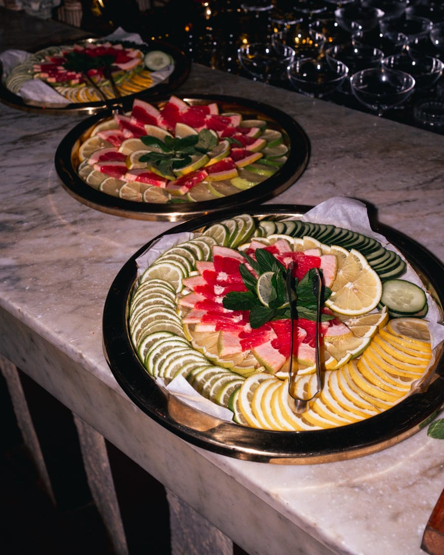 Platters of sliced fruit on the counter