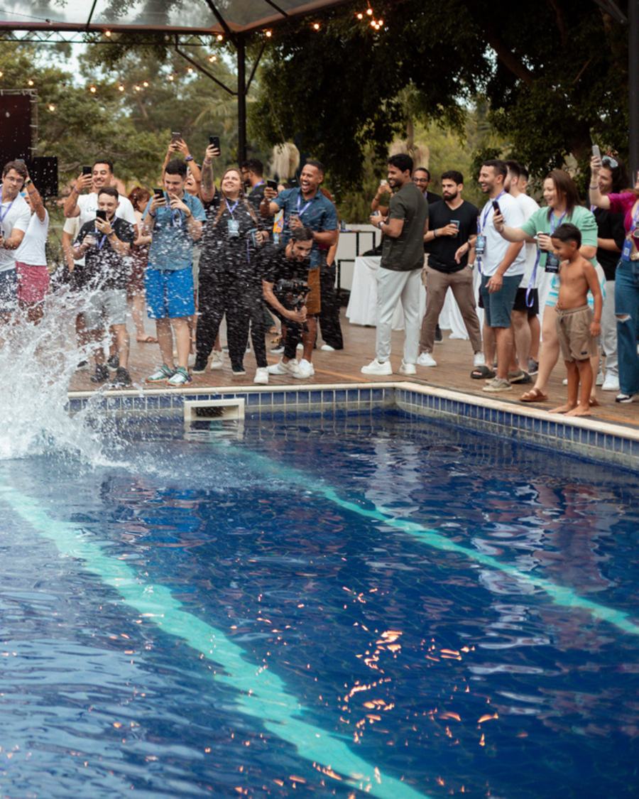 Guests around the pool filming a dive